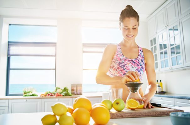 fit-young-woman-preparing-healthy-fruit-juice-PQZ97TY-min