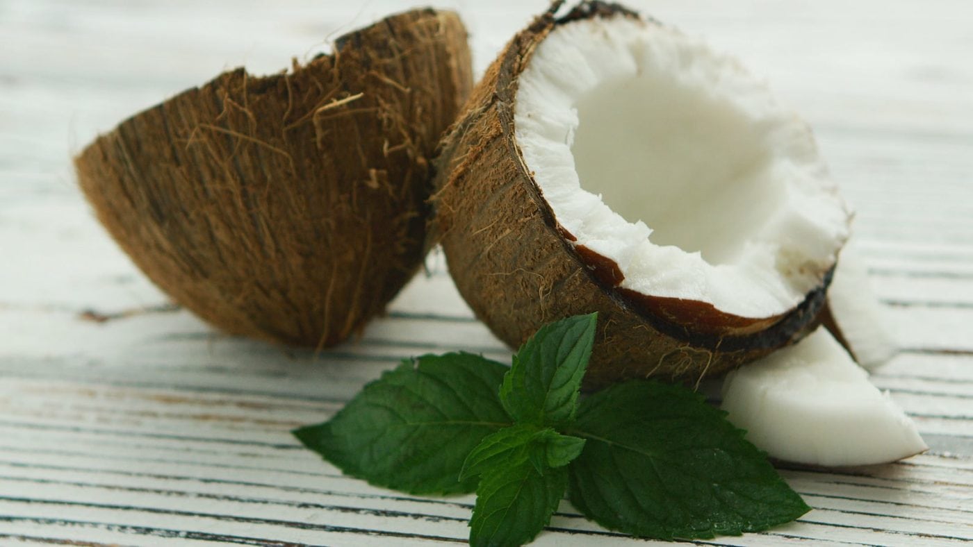 halves-of-fresh-coconut-with-mint-leaves-FZHXLUR-min