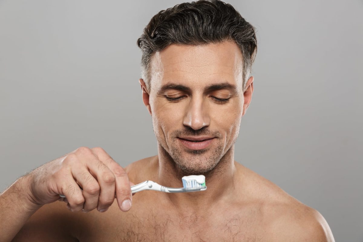 handsome-mature-man-brushing-his-teeth-BCTD5NM-min